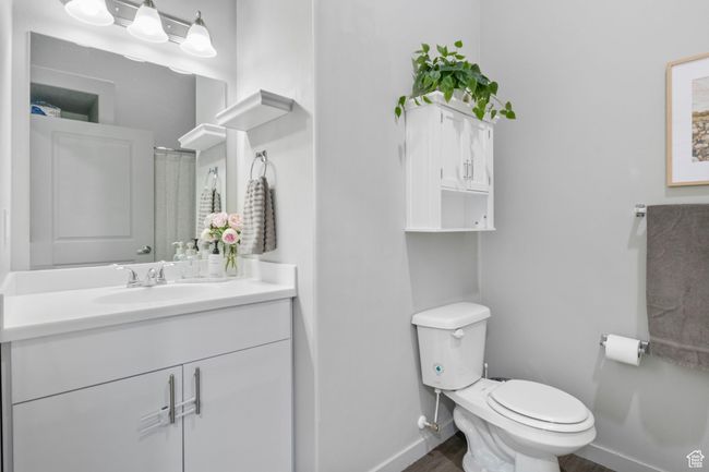 Bathroom with baseboards, toilet, vanity, and wood finished floors | Image 22