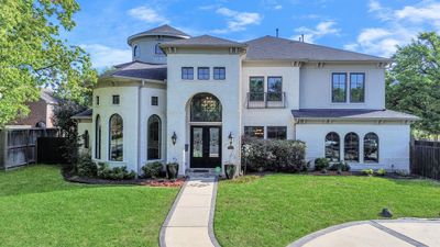 Custom build by Partners in Building, this beautiful stucco home with stunning rotunda and arches is laid out on a huge corner lot with circle driveway and lots of fabulous finishes! | Image 1