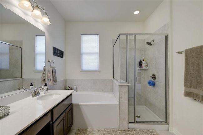 Full bath with plenty of natural light, a stall shower, and vanity | Image 21