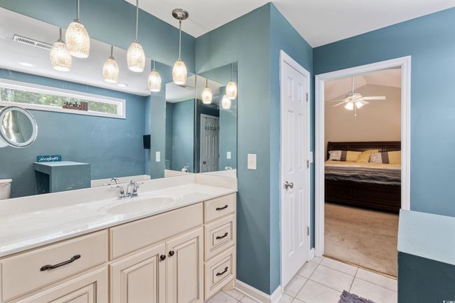 Full bathroom featuring ensuite bathroom, tile patterned floors, vanity, and a ceiling fan | Image 21