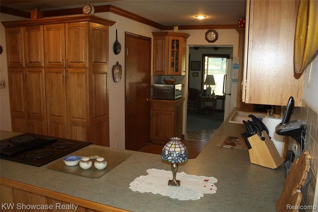 Kitchen, looking through to the sunroom. | Image 12