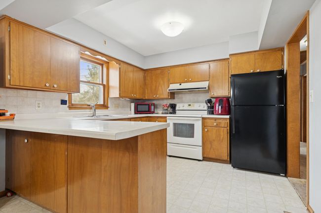 There is additional room for seating and ample storage space in this charming kitchen! | Image 6