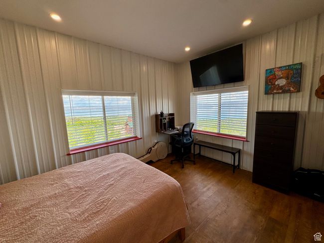 Primary Bedroom with wood-type floors, and recessed lighting, and new bedroom furniture | Image 15