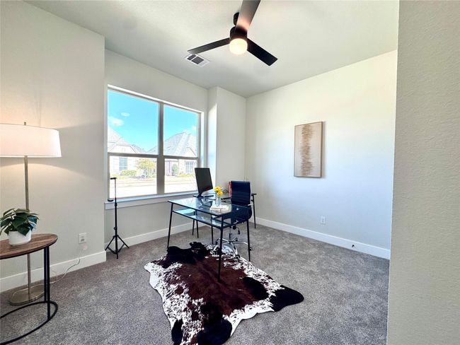Carpeted home office with a ceiling fan and baseboards | Image 6