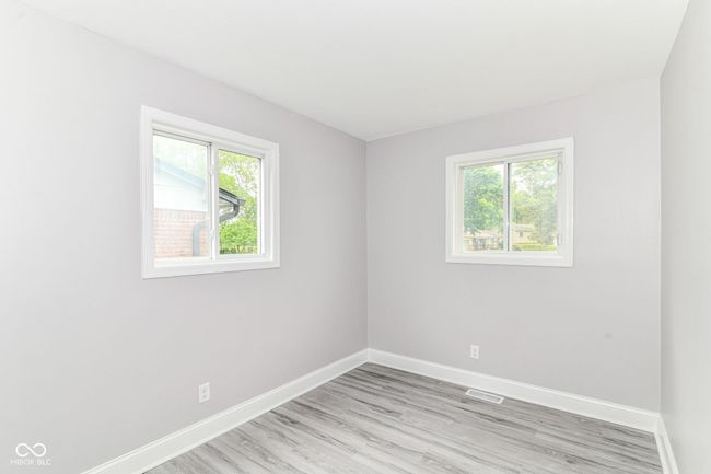 empty room with baseboards, plenty of natural light, and light wood finished floors | Image 16