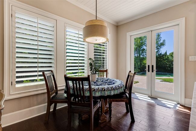 Dining area with ornamental molding, french doors, dark wood-style flooring, and baseboards | Image 6