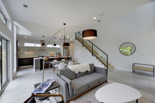 Living area featuring baseboards, recessed lighting, stairway, visible vents, and finished concrete floors | Image 4