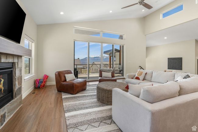 A spacious living room, offering a sense of warmth and elegance. featuring a fireplace, with easy access to a serene balcony. | Image 26