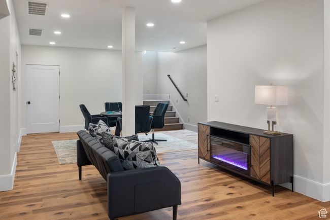 Living area with stairway, light wood-style flooring, and recessed lighting | Image 53