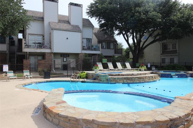 View of pool with a pool with connected hot tub, fence, and a patio area | Image 27