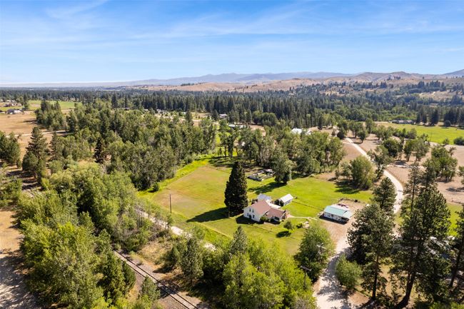 Aerial view of a mountainous background and a heavily wooded area | Image 5