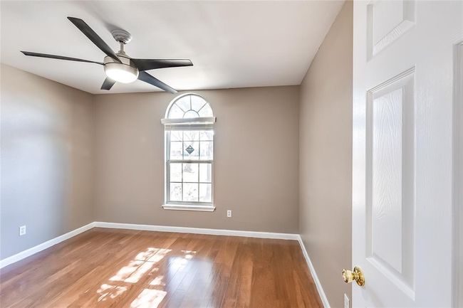 Unfurnished room with a ceiling fan and wood finished floors | Image 19