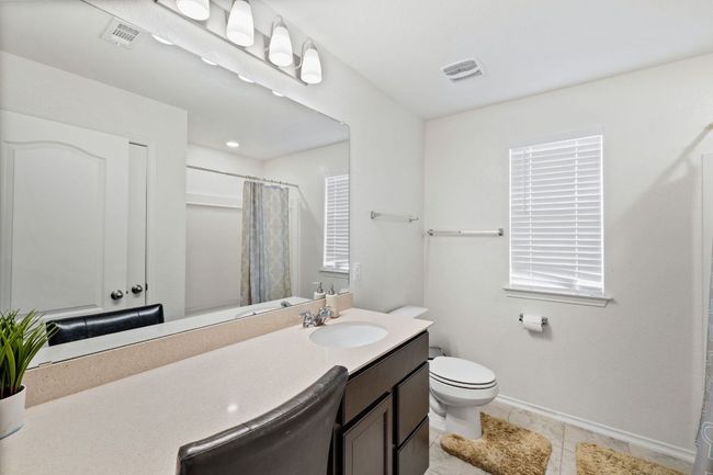 Full bath with vanity, a shower with shower curtain, and tile patterned flooring | Image 28