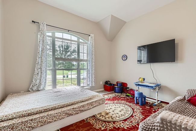 Bedroom with multiple windows and carpet floors | Image 19