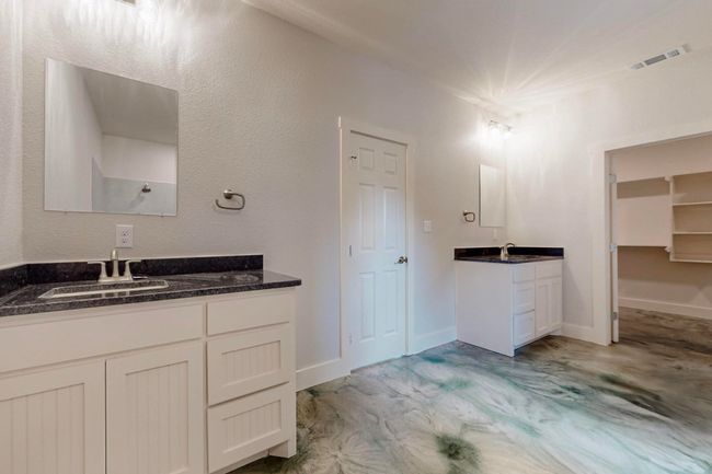 Bathroom with two vanities and concrete flooring | Image 33