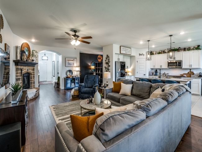 Living area featuring recessed lighting, a ceiling fan, arched walkways, and dark wood-type flooring | Image 12