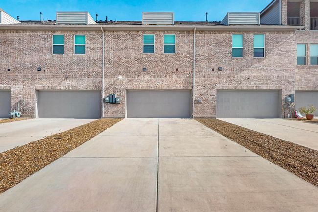 View of front of property with driveway, brick siding, and a garage | Image 32
