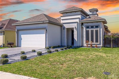 Prairie-style house with a lawn and a garage | Image 1