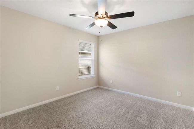 Carpeted room featuring a ceiling fan and baseboards | Image 17