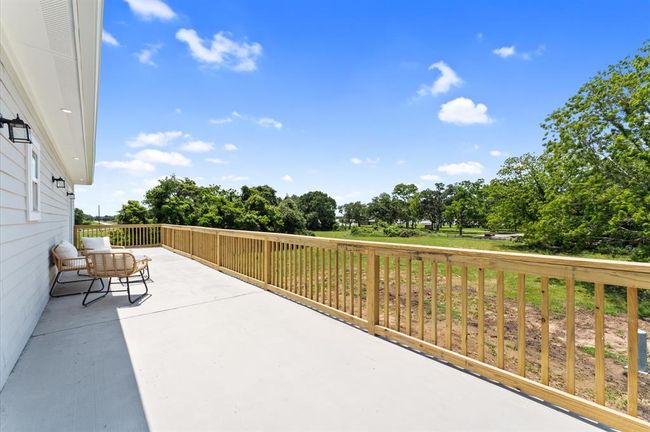 Primary suite offers direct access to a private balcony with lake views that spans the entire width of the home | Image 19