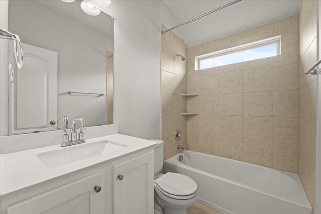 Bathroom featuring vanity and shower / tub combination | Image 24
