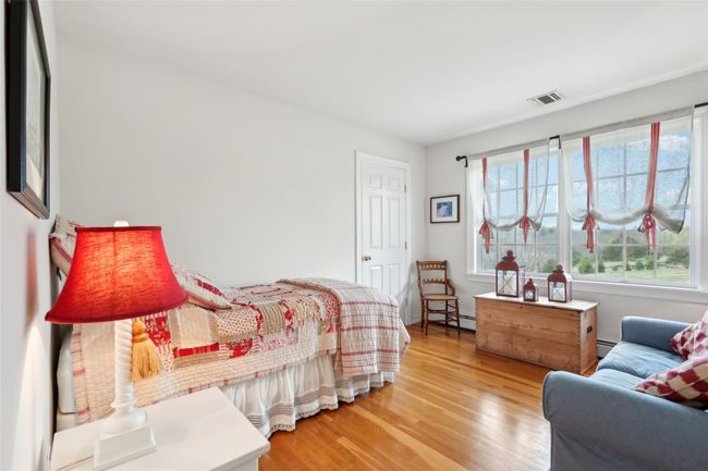 Bedroom featuring wood finished floors and visible vents | Image 35