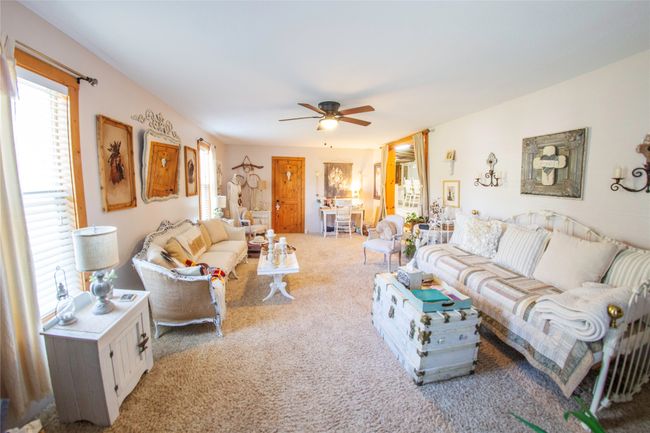 Carpeted living room with ceiling fan | Image 12