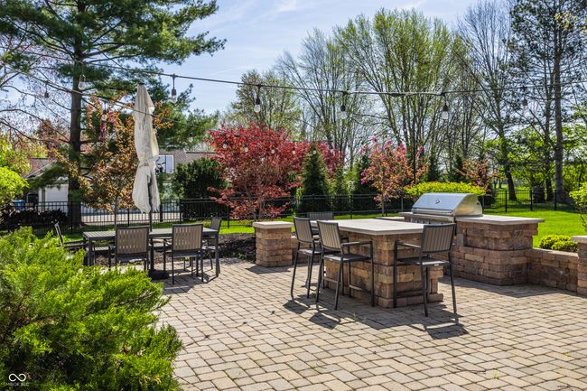 view of patio / terrace featuring outdoor dry bar, area for grilling, an outdoor kitchen, and fence | Image 51