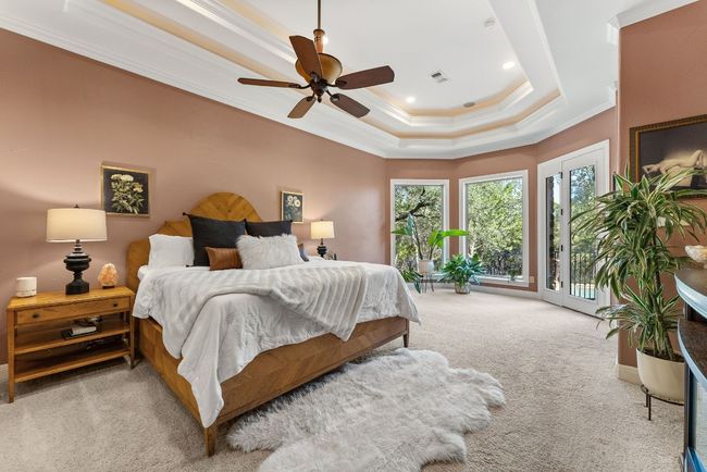 Main level Primary bedroom overlooking backyard and pool. | Image 13