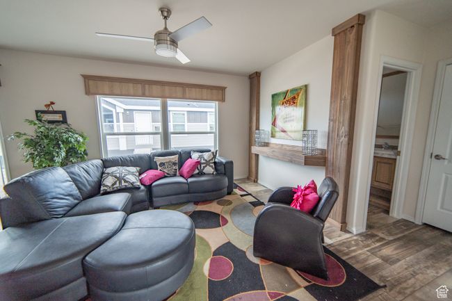 Living room featuring a ceiling fan and wood finished floors | Image 49