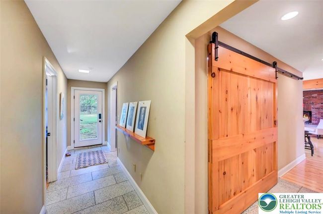 hall laundry w/ sliding door and door to patios | Image 27