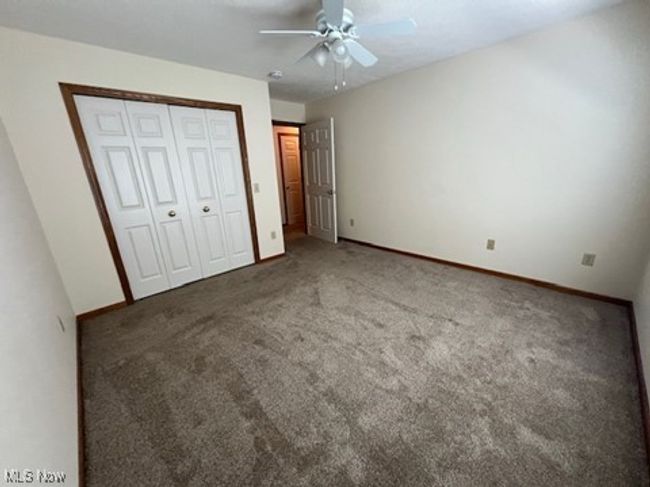 Unfurnished bedroom featuring carpet floors, a closet, and ceiling fan | Image 25
