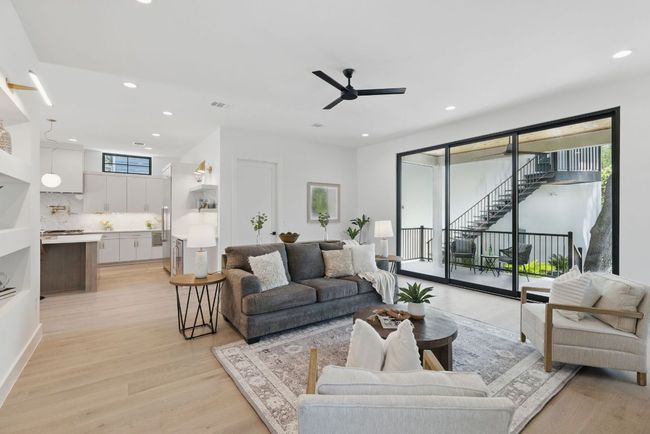 Living area with a ceiling fan, recessed lighting, and light wood-style floors | Image 11