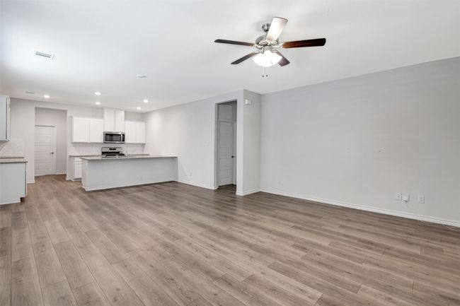 Unfurnished living room with ceiling fan, recessed lighting, and light wood finished floors | Image 10