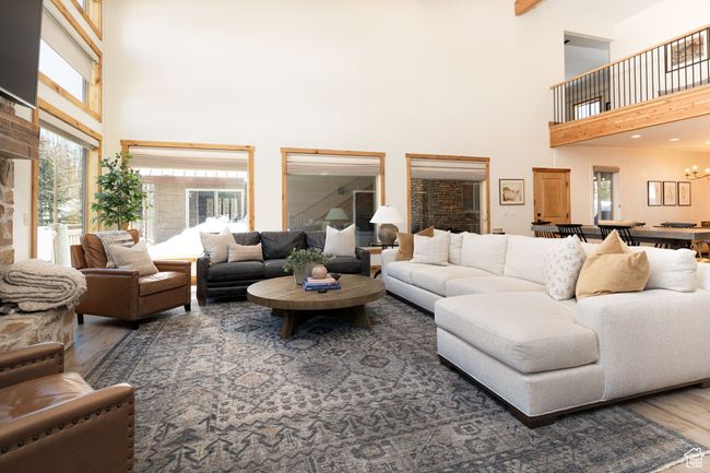 Living room with a towering ceiling and wood finished floors | Image 6