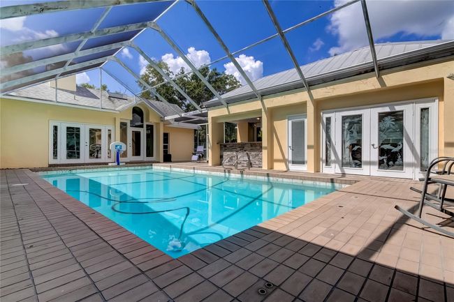 Pool looking at cabana and outdoor kitchen | Image 41