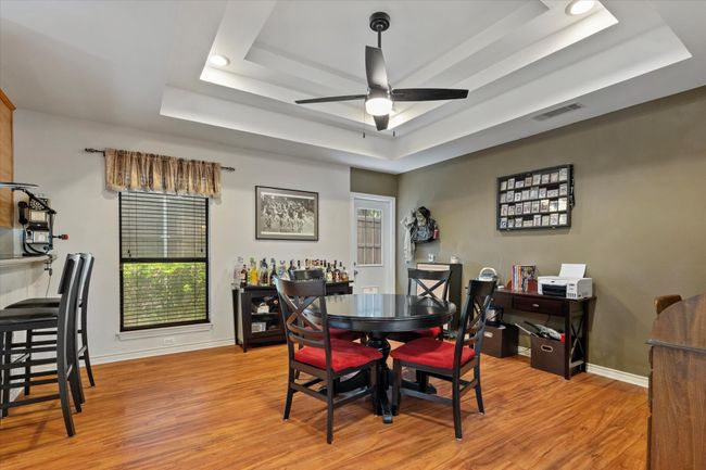 Dining space with a raised ceiling, light wood-type flooring, and baseboards | Image 20