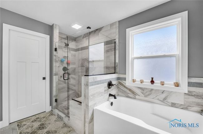 Primary Bathroom has a custom tile shower w/bench seating and a soaker tub. | Image 13