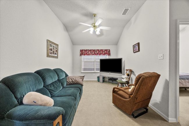 Carpeted living room featuring lofted ceiling and ceiling fan | Image 22