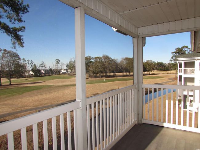 Screen porch with golf course view. | Image 36