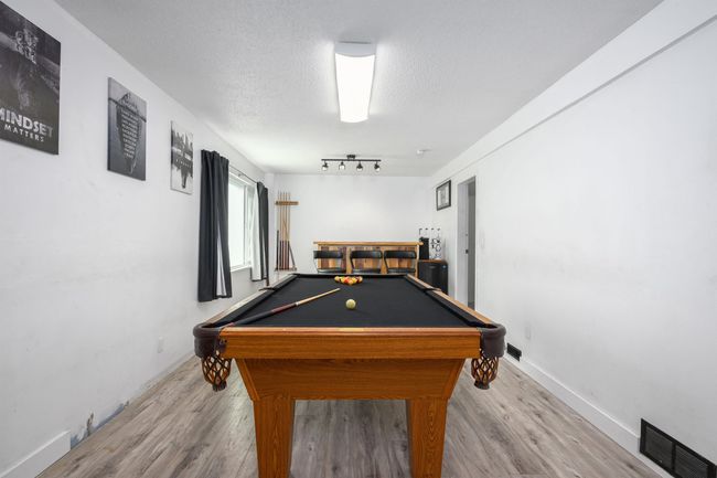 Playroom with pool table, wood finished floors, a textured ceiling, and baseboards | Image 28