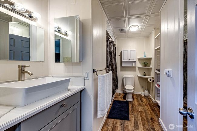 The updated primary bath with plenty of storage space. | Image 20