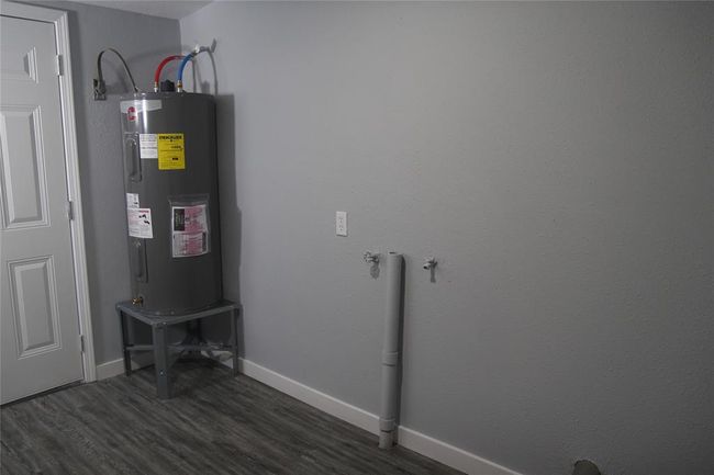 Hot water heater located in utility room. Door to the left leads to your large backyard | Image 26