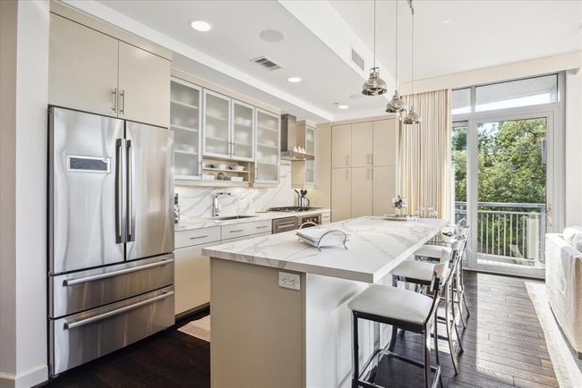 Another view of the kitchen showing ample storage. | Image 10