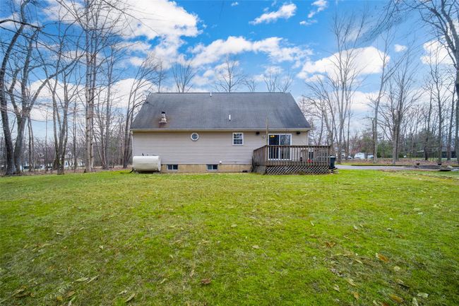 Rear view of house with a wooden deck | Image 39