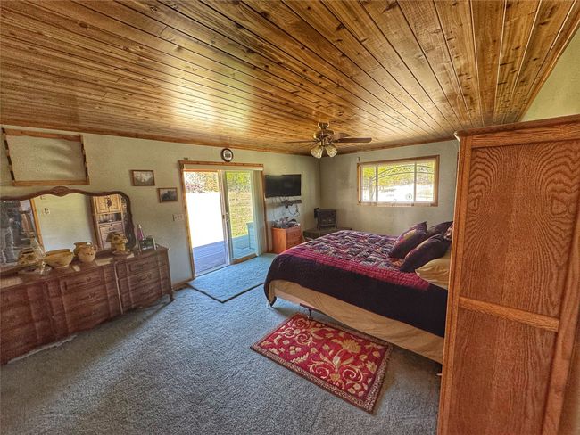 Main level bedroom with sliding glass doors to covered porch | Image 26