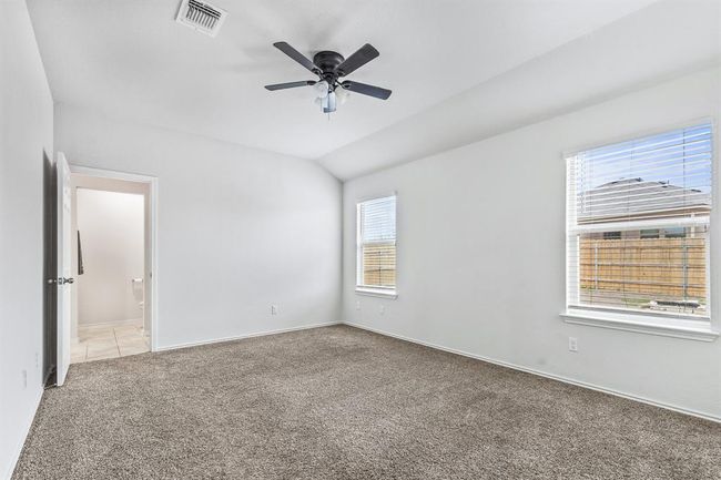 Unfurnished room with carpet floors, a ceiling fan, and vaulted ceiling | Image 8