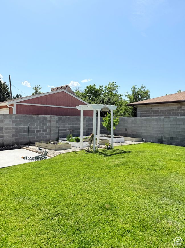 Fenced backyard with a garden | Image 25