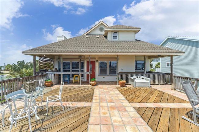 Charming bay home with a spacious, sunlit deck perfect for outdoor entertaining. | Image 6