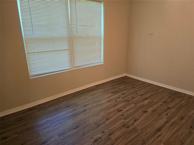 Empty room featuring dark wood-style floors and baseboards | Image 13